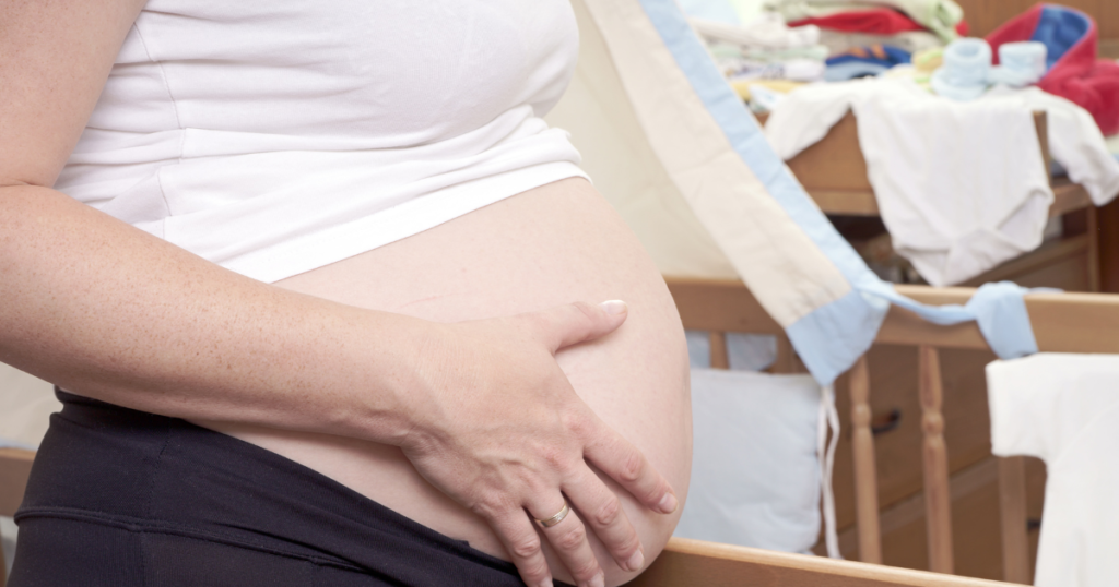 Pregnant women organizing baby clothing