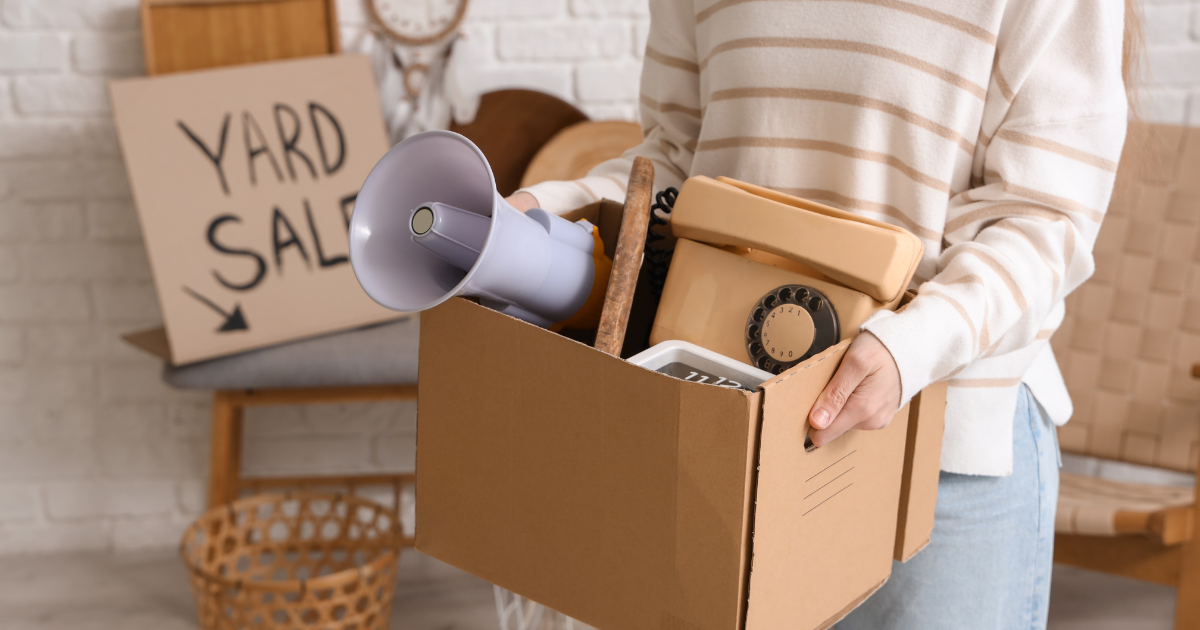 Girl with box at a yard sale